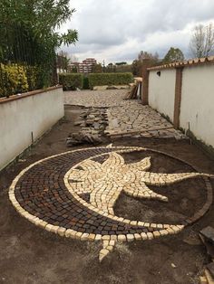 a brick walkway with a circular design on it