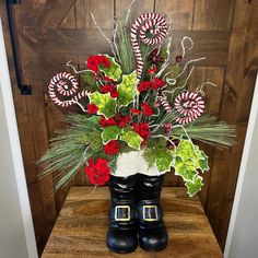 a vase filled with candy canes and flowers