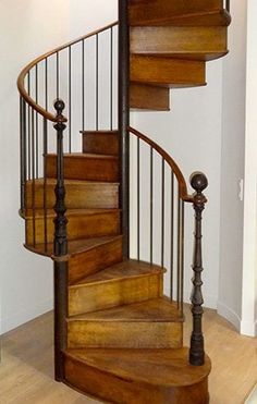 there is a wooden spiral staircase in the house