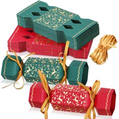 three boxes with bows tied around them and one box is green, the other red