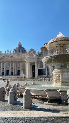 a fountain in front of a large building