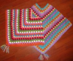 two crocheted dishcloths sitting on top of a wooden floor