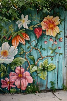 a painted wooden fence with flowers on it