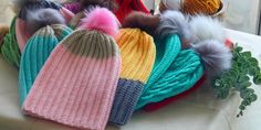 several knitted hats are sitting on a table