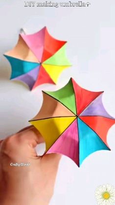 someone is holding three colorful umbrellas in their hand with the caption, it's amazing how to make an umbrella out of paper