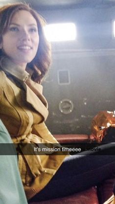 a woman sitting in the back of a car on top of a brown leather chair