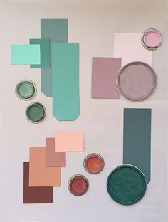 several different colors of paint sitting on top of a white surface next to each other