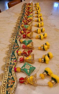 a long table topped with lots of yellow and green items on top of a marble counter