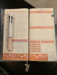 an open planner book with a pen on it