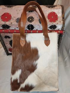 Cowhide Tote - Cowhide Fur Handbag - Brown and White fur handbag on cowhide one side is totally  brown and the other side is white -100% Natural hair on real cowhide leather on both sides of the bag -Genuine Leather Handles  -The interior is silk cloth -the gusset as well as the base of the cowhide tote are made from good quality leather - major compartment with zipper closure  -small zip pocket inside to keep your valuables -mobile phone pocket  Measurment -Height : 35 cm -lenght :   28 cm -Wid Fur Handbag, Fur Handbags, Cowhide Bag, Cow Skin, White Fur, Leather Handles, Leather Handle, Cowhide Leather, Purses And Handbags