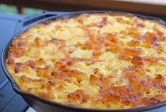 a close up of a pizza in a pan on top of a stove burner