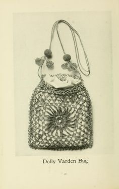 an old photo of a crocheted bag with pom poms on it