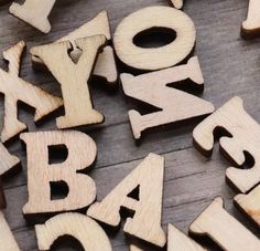 wooden letters spelling out the word abc and w are arranged on top of each other