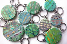 a close up of many different colored buttons on a keychain with metal rings