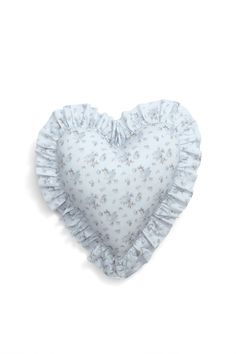 a heart shaped pillow with ruffles on the sides and a small flower pattern