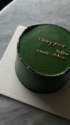 a green cake sitting on top of a white plate