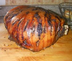 a large meat sitting on top of a wooden cutting board