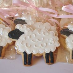 three decorated cookies in the shape of sheep