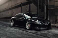 a black car parked in front of a building