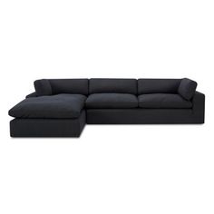 a black sectional couch sitting on top of a white floor