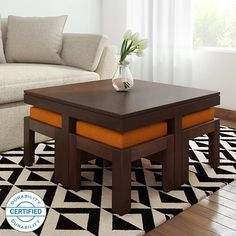 a living room with a white couch and coffee table in front of a black and white rug