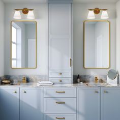 a bathroom with two sinks, mirrors and gold trimmings on the cabinets in front of them