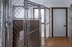 the inside of a jail cell with wooden floors and metal bars on the doors,