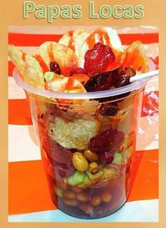 a plastic cup filled with food on top of a table