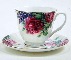 a cup and saucer with flowers painted on it