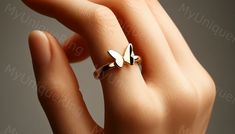 *Free engravings up to 20 characters* 😊 flutter into the delicate charm of nature with this bewitching minimalist butterfly ring! 🌟 it's a soft whisper of whimsy, a graceful ornament for your finger or a magical gift for that cherished one who delights in the fluttery wonders of the garden. 🦋💖 let's flutter into versatility, this ring is perfect for stacking or wearing solo, creating a gentle yet captivating charm. meticulously crafted, it showcases a minimalist butterfly design along a delicate band, mingling a breath of whimsy with a touch of elegance. it's as stylish as it is endearing, ready to accompany you through sunlit days or enchanting garden soirees. whether you're cherishing the whimsical allure of butterflies or simply in search of that dreamy piece of jewelry, this butter Minimalist Butterfly Ring As A Gift, Minimalist Butterfly Ring As Gift, Minimalist Butterfly Ring For Gift, Dainty Butterfly Charm Rings, Dainty Rings With Butterfly Charm, Elegant Rings With Butterfly Charm For Gift, Dainty Butterfly Rings With Charm, Elegant Sterling Silver Rings With Butterfly Charm, Elegant Butterfly Ring Gift