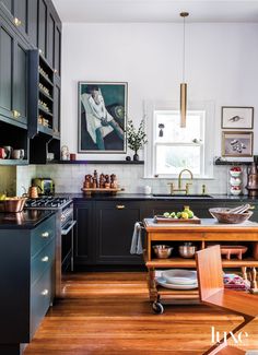 the kitchen is clean and ready for us to use it's wood flooring