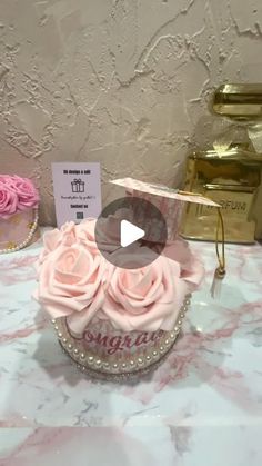 there is a cupcake with pink roses in it on the table next to other cakes