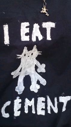 a t - shirt with the words i eat cement written on it and a cat