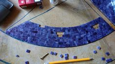 a blue mosaic tile design with a pencil and eraser