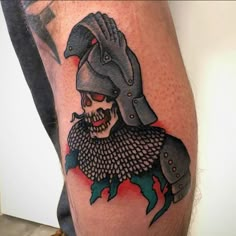 a man's arm with a tattoo on it and a skull wearing a helmet