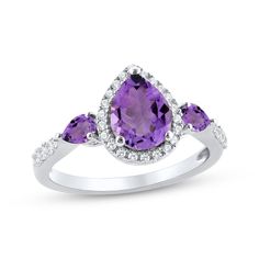 This dreamy ring showcases a gorgeous pear-shaped amethyst enveloped by shimmering round white lab-created sapphires at the center. Two smaller pear-shaped amethysts are set horizontally on the flanks for a vibrant and dynamic design. The band is further adorned in white lab-created sapphires, adding an extra touch of sparkle. The ring is crafted in classic sterling silver with a rhodium finish. Teardrop Shaped Brilliant Cut Jewelry For Promise Ring, Elegant Teardrop Diamond Ring With Accent Stones, Elegant Pear-shaped Gemstone Birthstone Ring, Formal Teardrop Amethyst Ring In Fine Jewelry Style, Elegant Teardrop Amethyst Ring, Diamond White Teardrop Promise Ring, Elegant Teardrop Amethyst Gemstone Ring, Elegant Teardrop Purple Amethyst Ring, Purple Teardrop Amethyst Ring For Anniversary