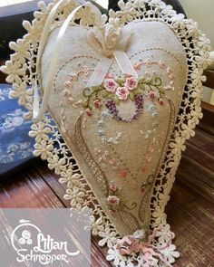 a heart shaped pillow sitting on top of a table