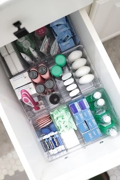 the drawers are organized with various items such as toothbrushes and other hygiene products