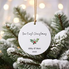 a personalized ornament hanging from a christmas tree