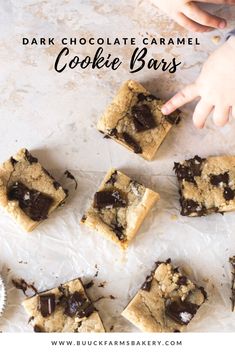 chocolate caramel cookie bars are cut into squares and placed on top of parchment paper