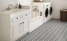 a washer and dryer in a bathroom with black and white tile flooring