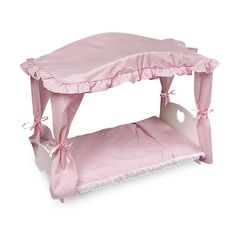 a pink and white bed with a canopy over it's headboard on a white background