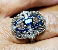 This ladies ring is a size 7 and 3/4. It is mint condition and a deco style with blue sapphires and diamonds. The ring is stamped 14K Meda and is 14K SOLID WHITE GOLD.  Beautiful ring and very detailed workmanship. Front of ring measures 7/8 inch long and 3/4 inch wide. Center stone is a sapphire baquette  with 16 small round Channel set sapphires and 10 small 1 point Genuine Diamonds. I will provide free shipping which includes insurance! Ruby Rings, Ladies Ring, Wedding Aesthetic, Ring Ideas, Rocks And Gems, Shiny Things, Channel Set, White Gold Ring