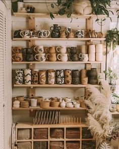 the shelves are filled with coffee cups and other things on display in front of them