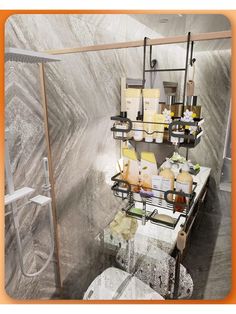 a shelf with soaps and other items on it next to a toilet in a bathroom