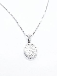 Miraculous Medal In Sterling Silver 925 set with Cubic Zirconia on Silver Chain. Medal size: 15mm Chain length:44cm/17.32 inch Engraved Sterling Silver Necklace In Diamond White, Sterling Silver Medallion With Diamond Cut, Engraved White Gold Necklace With Cubic Zirconia, White Gold Sterling Silver Necklace With Oval Pendant, Silver Initial Pendant With Diamond Cut, Diamond White Sterling Silver Initial Pendant Jewelry, Diamond White Sterling Silver Jewelry With Initial Pendant, Sterling Silver Oval Pendant Necklace For Mother's Day, Sterling Silver Oval Pendant With Diamond Cut