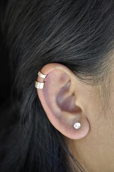 a woman's ear is shown with two different piercings on the top and bottom