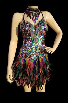 Rainbow Feather Sequin Party Dress. These sequins and feathers shimmy as you dance catching the light and bedazzling bystanders. Fitted with a zipper at the back with hook to stay secure. Loops on the side to tie at the back which tightens the padded bra piece on the front for that snug fit. Each sequin and feather are sewn on individually onto a polyester stretch fabric. Fits UK size 10 -12. Only a few pieces this style and colour so when they're gone they're gone!  NECKLACE SOLD SEPARATELY. Fitted Sequin Dress For Carnival, Feathered Dresses For Costume Party, Sequin Dress For Carnival Costume Party, Sequin Dress For Costume Party And Carnival, Masquerade Party Dresses, Rainbow Sequin Dress, Rave Leggings, Holographic Dress, Rave Party