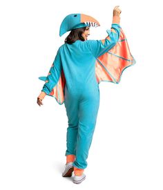 a woman in a blue dragon costume is standing with her arms up and one arm raised