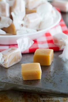 two pieces of cheese sitting on top of a baking sheet next to some other food